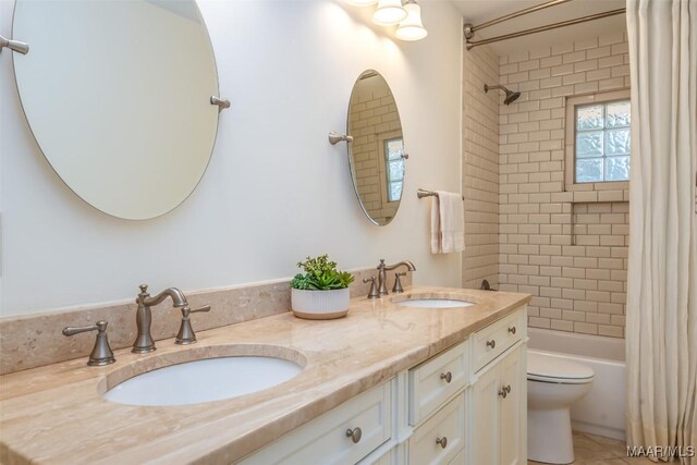 3469 Warrenton Rd, Montgomery, AL 36111 - full bath featuring shower / bathtub combination with curtain, toilet, double vanity, and tile patterned floors