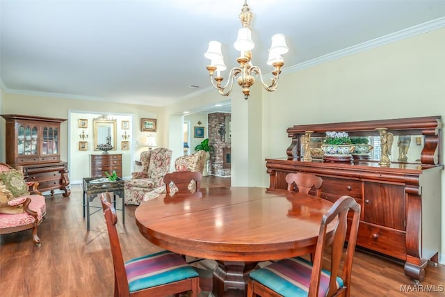 3469 Warrenton Rd, Montgomery, AL 36111 - dining space featuring a chandelier, crown molding, wood finished floors, and baseboards