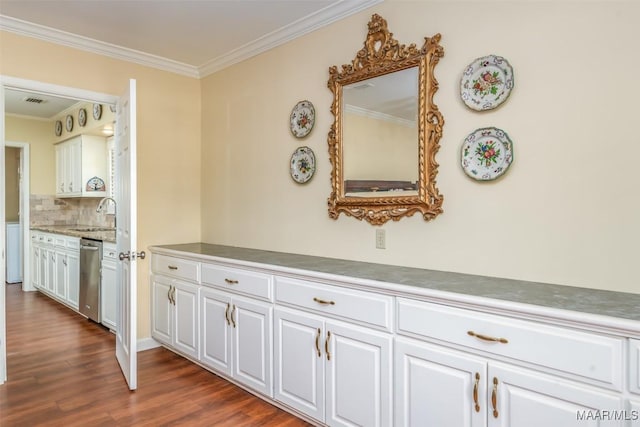3469 Warrenton Rd, Montgomery, AL 36111 - kitchen featuring stainless steel dishwasher, crown molding, white cabinetry, decorative backsplash, and dark wood finished floors