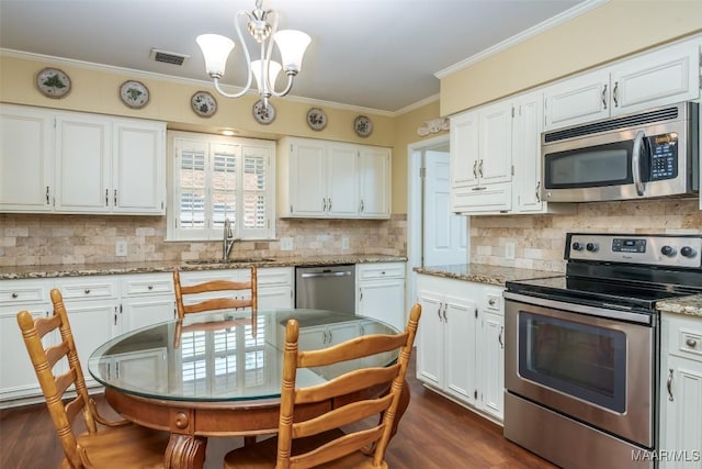 3469 Warrenton Rd, Montgomery, AL 36111 - kitchen with appliances with stainless steel finishes, a sink, a chandelier, dark wood finished floors, and white cabinets