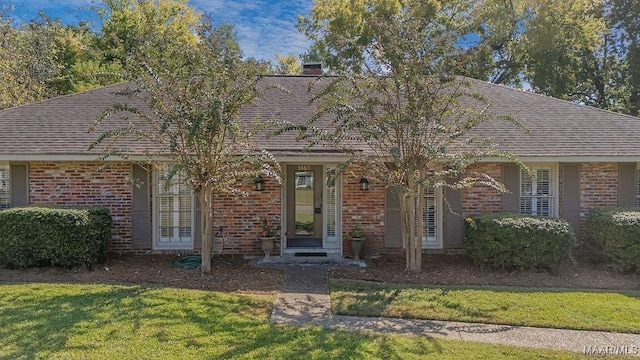 3469 Warrenton Rd, Montgomery, AL 36111 - view of front of house with brick siding, a shingled roof, and a front yard