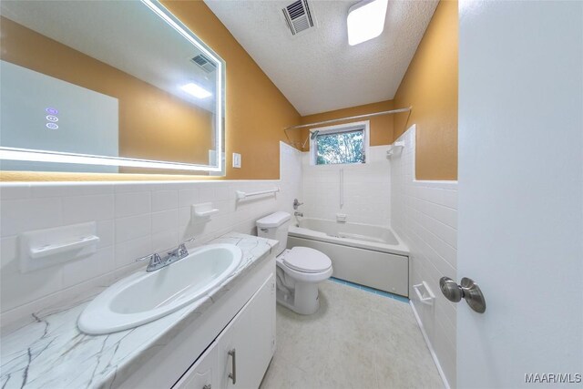 362 Bellehurst Dr, Montgomery, AL 36109 - bathroom featuring tile walls, a wainscoted wall, vanity, a textured ceiling, and bathing tub / shower combination