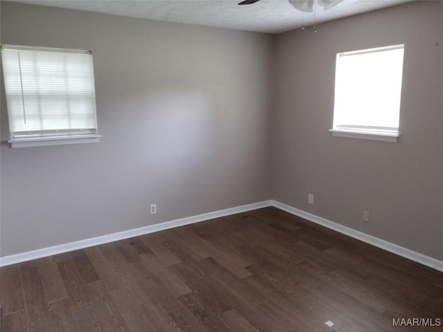 3950 Main St, Millbrook, AL 36054 - unfurnished room with dark wood-style flooring, a ceiling fan, and baseboards