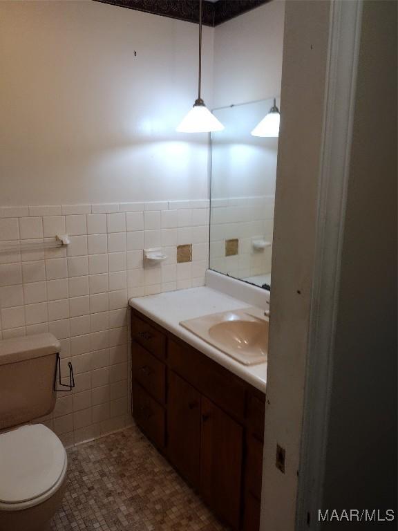 3950 Main St, Millbrook, AL 36054 - bathroom with vanity, tile walls, and toilet