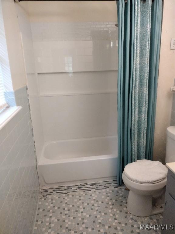 3950 Main St, Millbrook, AL 36054 - bathroom featuring toilet, shower / bath combo with shower curtain, vanity, and tile walls