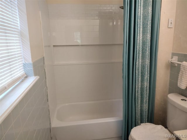 3950 Main St, Millbrook, AL 36054 - full bathroom with tile walls, toilet, shower / bath combo, and a wainscoted wall