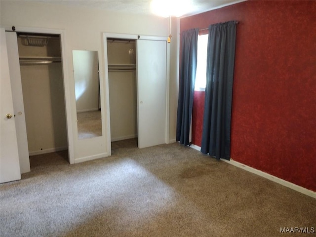 3950 Main St, Millbrook, AL 36054 - unfurnished bedroom featuring two closets, carpet flooring, and baseboards