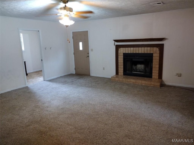 3950 Main St, Millbrook, AL 36054 - unfurnished living room featuring a ceiling fan, a brick fireplace, a textured ceiling, carpet, and baseboards