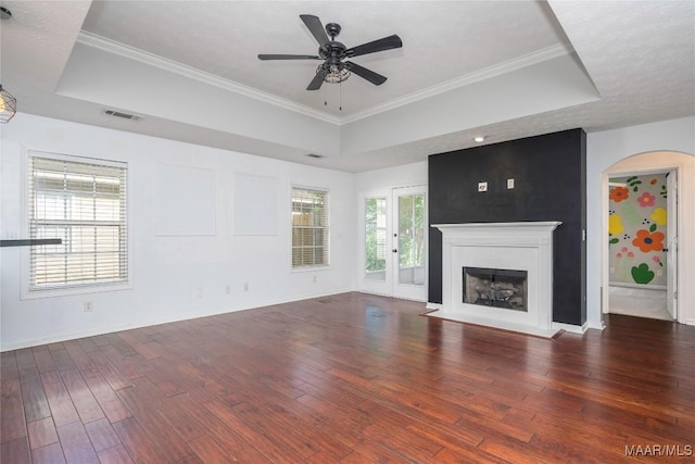 1600 Hawthorne Ln, Prattville, AL 36066 - unfurnished living room with a tray ceiling, wood finished floors, a ceiling fan, baseboards, and a fireplace with flush hearth