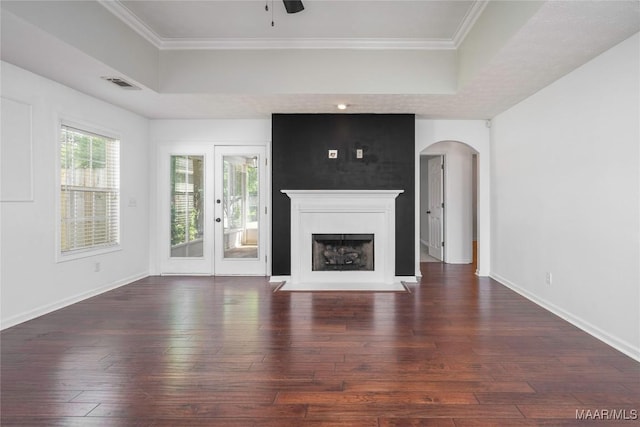 1600 Hawthorne Ln, Prattville, AL 36066 - unfurnished living room featuring hardwood / wood-style floors, a raised ceiling, arched walkways, a fireplace with flush hearth, and a ceiling fan