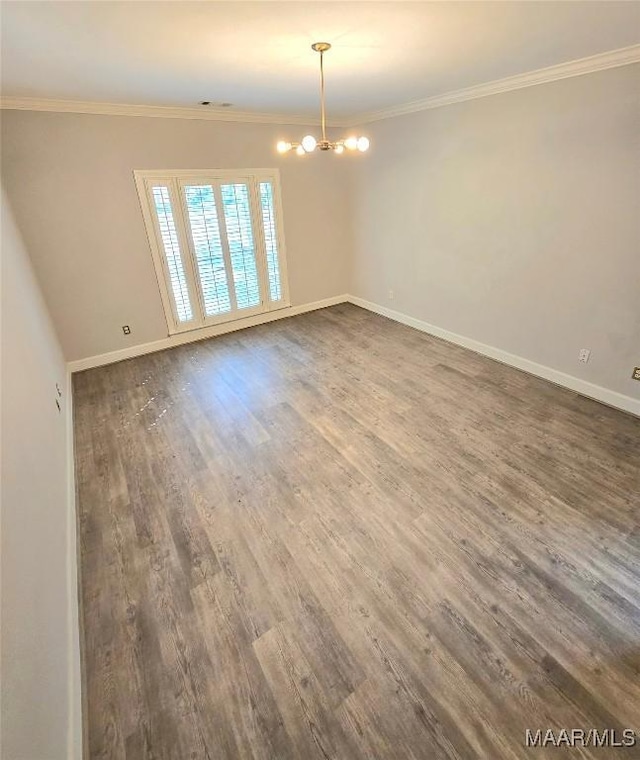49 Berkeley Rd, Selma, AL 36701 - empty room featuring a chandelier, dark wood finished floors, ornamental molding, and baseboards