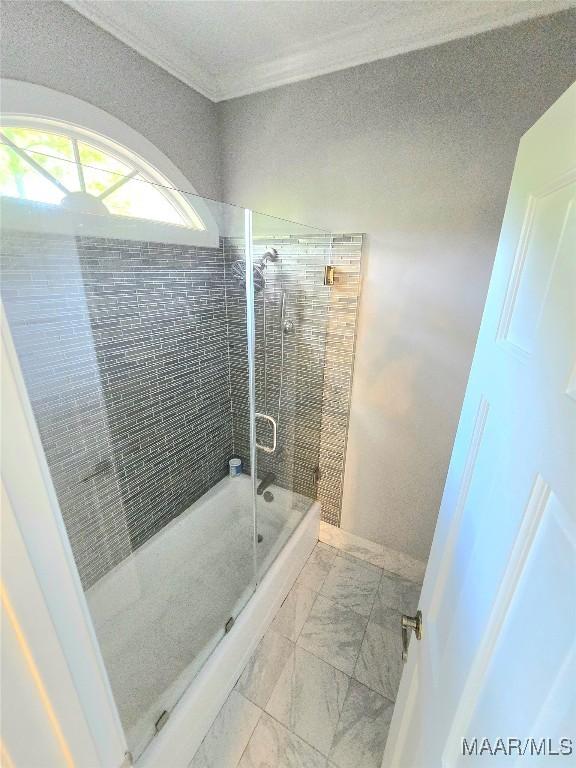 49 Berkeley Rd, Selma, AL 36701 - bathroom featuring a shower stall, marble look tiles, and crown molding