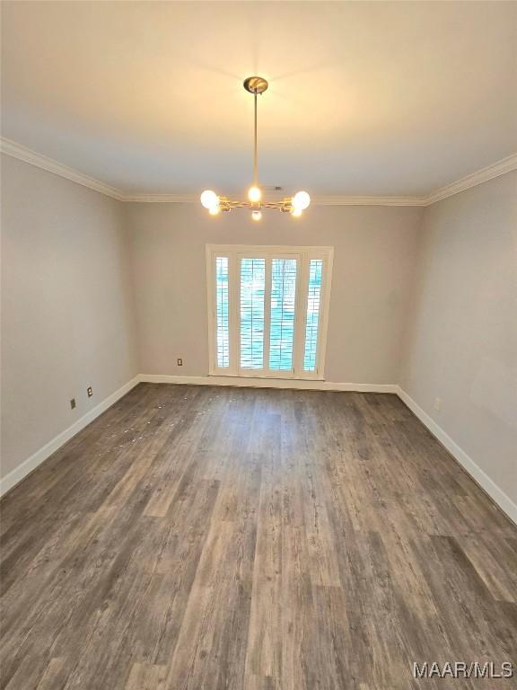 49 Berkeley Rd, Selma, AL 36701 - empty room with a chandelier, dark wood-type flooring, baseboards, and ornamental molding