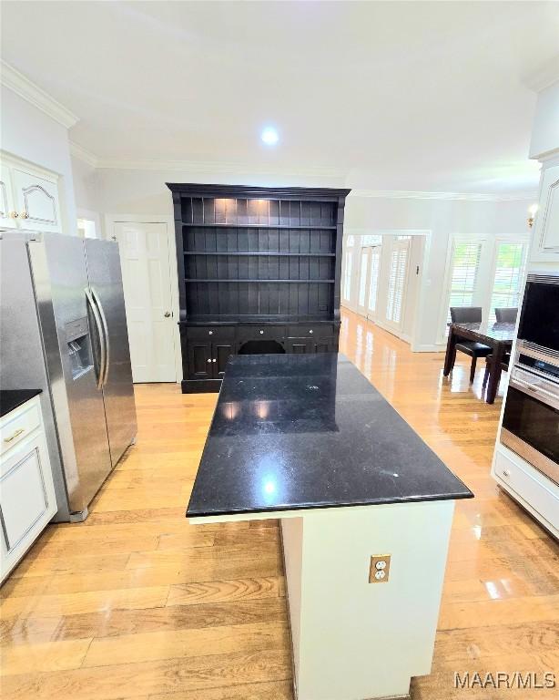49 Berkeley Rd, Selma, AL 36701 - kitchen featuring stainless steel appliances, open shelves, light wood-style floors, crown molding, and white cabinets