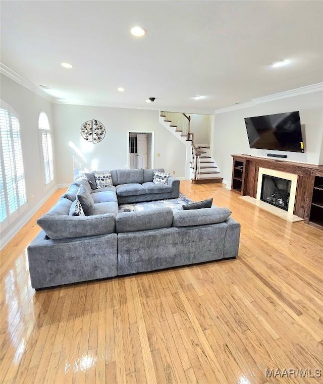 49 Berkeley Rd, Selma, AL 36701 - living room featuring stairway, crown molding, hardwood / wood-style flooring, a fireplace with flush hearth, and recessed lighting