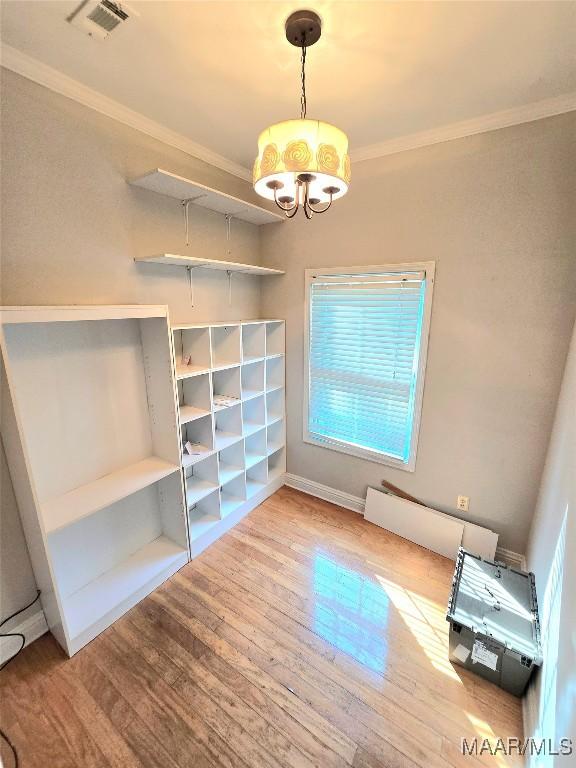 49 Berkeley Rd, Selma, AL 36701 - unfurnished dining area with ornamental molding, wood finished floors, a chandelier, and baseboards