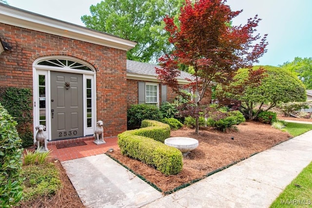 doorway to property with brick siding