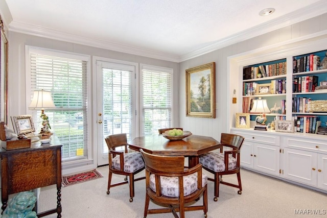 dining space featuring light carpet and ornamental molding