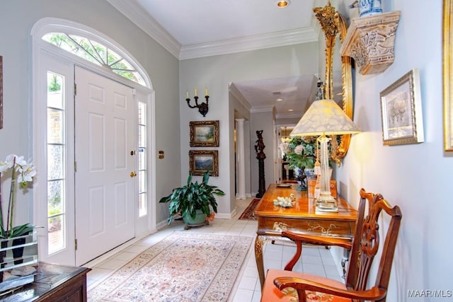 entrance foyer featuring light tile patterned floors, crown molding, and baseboards