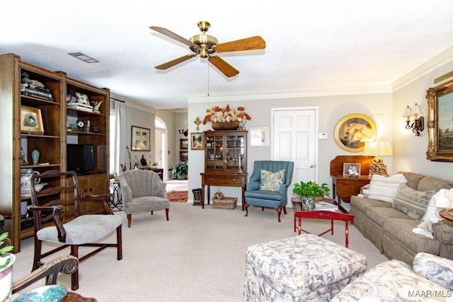 carpeted living room with a ceiling fan and crown molding