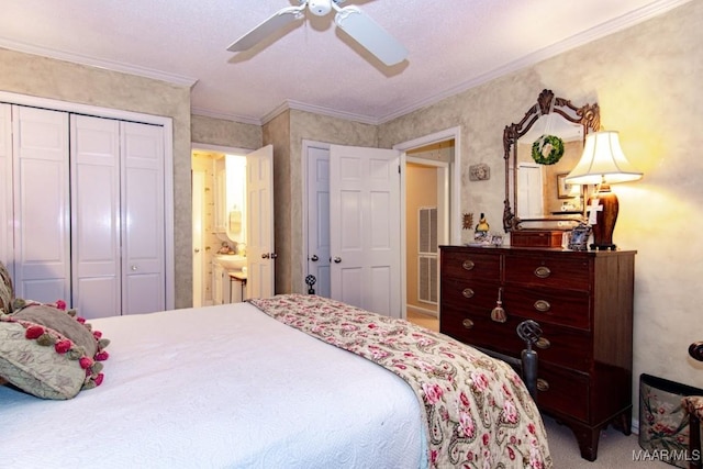 bedroom with carpet floors, ceiling fan, crown molding, and a closet