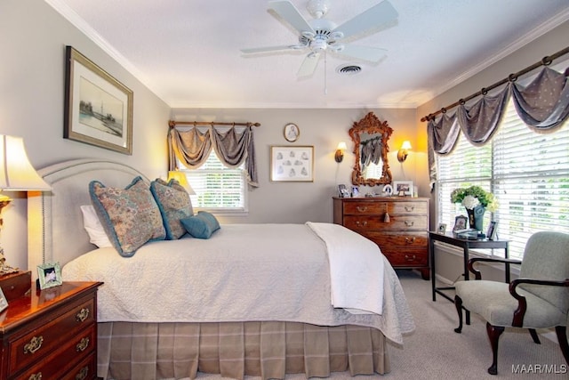 carpeted bedroom featuring ornamental molding and a ceiling fan