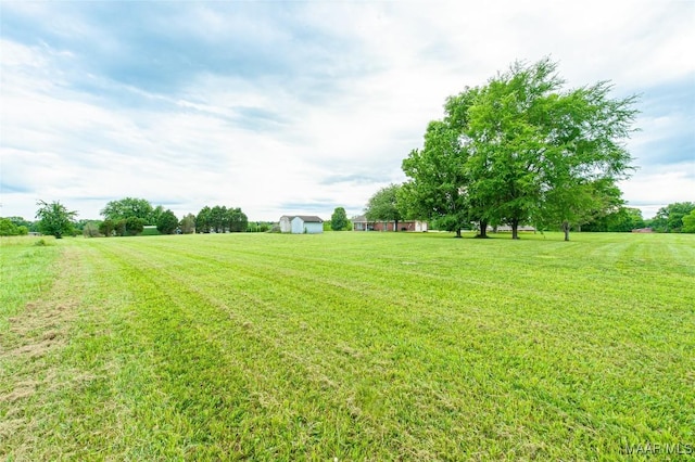 331 Bush Dr, Hope Hull, AL 36043 - view of green lawn featuring an outbuilding, a shed, and a view of rural / pastoral area