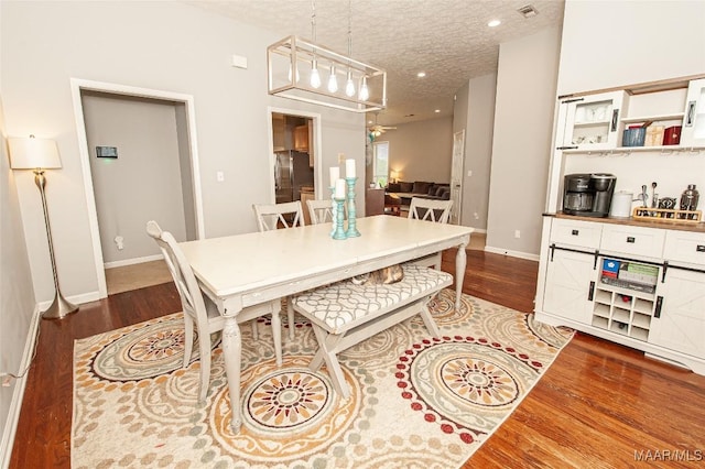 331 Bush Dr, Hope Hull, AL 36043 - dining room featuring dark wood-style flooring, baseboards, and a textured ceiling