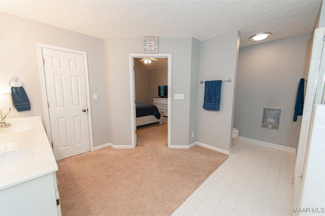 331 Bush Dr, Hope Hull, AL 36043 - full bathroom featuring toilet, a textured ceiling, baseboards, double vanity, and tile patterned floors
