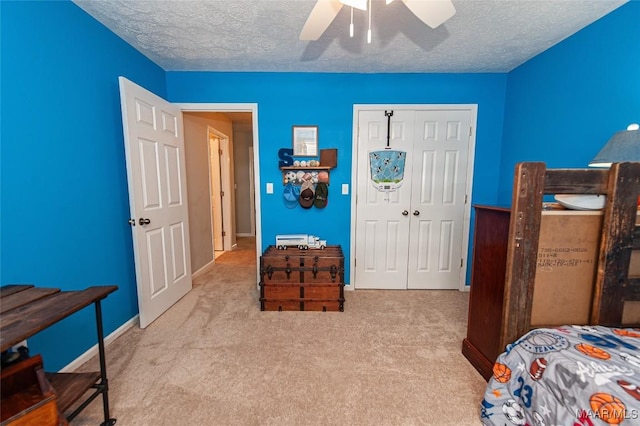 331 Bush Dr, Hope Hull, AL 36043 - carpeted bedroom featuring a closet, a textured ceiling, ceiling fan, and baseboards
