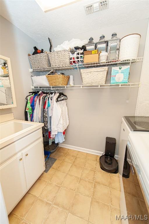 331 Bush Dr, Hope Hull, AL 36043 - walk in closet with separate washer and dryer, a sink, and light flooring