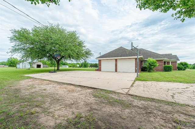 331 Bush Dr, Hope Hull, AL 36043 - view of side of property with a garage, a yard, brick siding, driveway, and roof with shingles