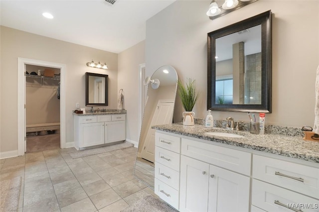 1412 Wildlife Way, Prattville, AL 36066 - full bath featuring two vanities, a walk in closet, baseboards, and recessed lighting