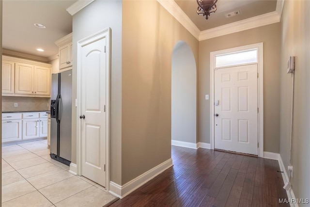 5906 Amberwood Ln, Montgomery, AL 36116 - entrance foyer featuring crown molding, arched walkways, light wood-style floors, and recessed lighting