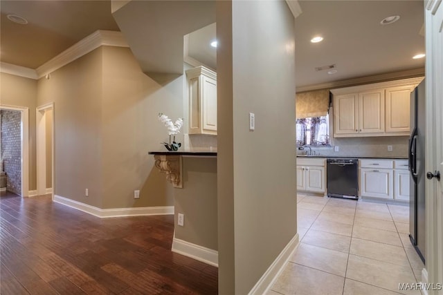 5906 Amberwood Ln, Montgomery, AL 36116 - kitchen featuring black dishwasher, crown molding, dark countertops, tasteful backsplash, and recessed lighting