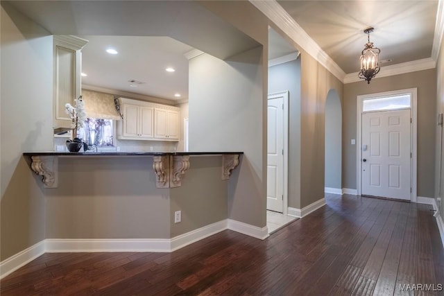 5906 Amberwood Ln, Montgomery, AL 36116 - entryway with hardwood / wood-style flooring, crown molding, a chandelier, arched walkways, and recessed lighting