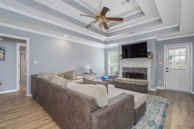 1274 Cross Creek Rd, Prattville, AL 36067 - living room with a ceiling fan, a fireplace, a raised ceiling, wood finished floors, and baseboards