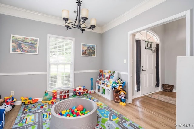 1274 Cross Creek Rd, Prattville, AL 36067 - recreation room featuring a chandelier, wood finished floors, and ornamental molding