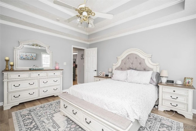 1274 Cross Creek Rd, Prattville, AL 36067 - bedroom with a tray ceiling, wood finished floors, ornamental molding, ceiling fan, and baseboards