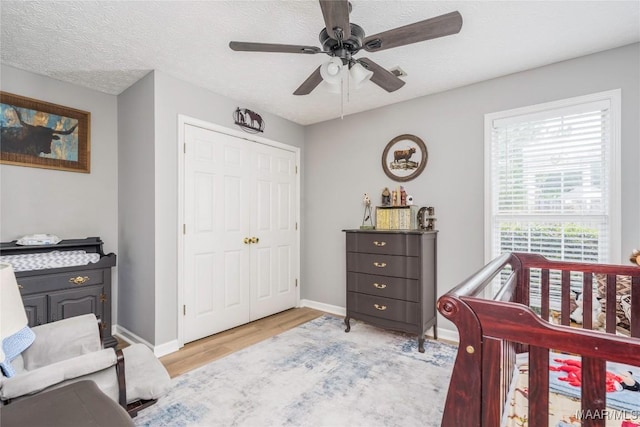 1274 Cross Creek Rd, Prattville, AL 36067 - bedroom with light wood-style floors, a closet, baseboards, and a ceiling fan