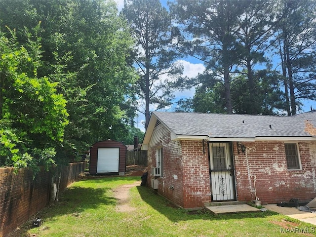 305 Sterling Dr, Montgomery, AL 36109 - back of property with brick siding, a shingled roof, a storage shed, and an outdoor structure