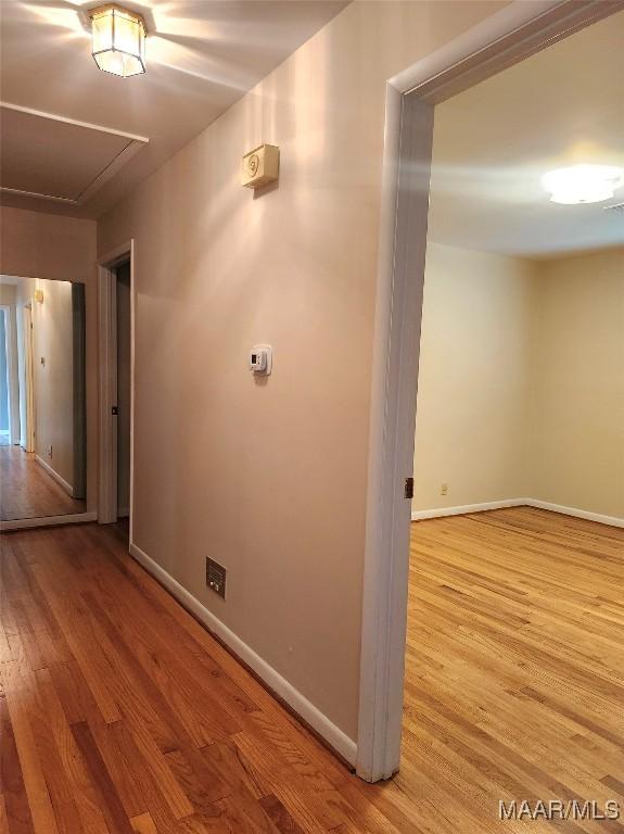 305 Sterling Dr, Montgomery, AL 36109 - hall featuring attic access, wood finished floors, and baseboards