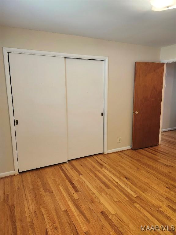 305 Sterling Dr, Montgomery, AL 36109 - unfurnished bedroom with light wood finished floors, a closet, and baseboards