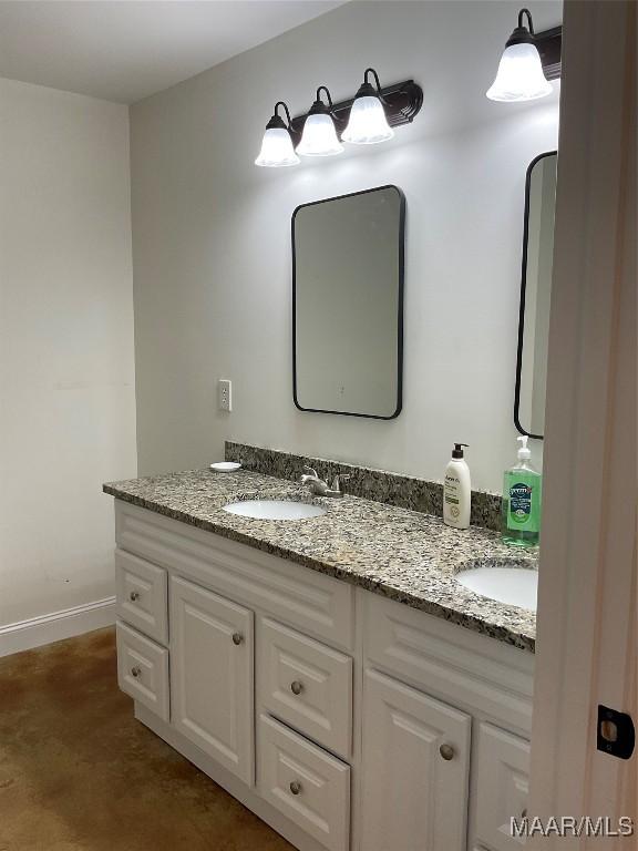 215 Indian Ln, Tallassee, AL 36078 - bathroom featuring double vanity and baseboards