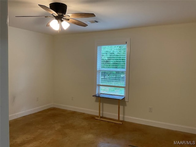215 Indian Ln, Tallassee, AL 36078 - unfurnished room featuring ceiling fan, concrete floors, and baseboards
