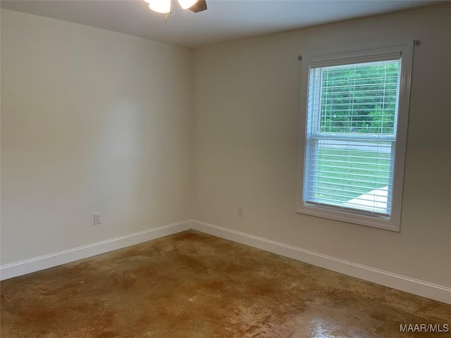 215 Indian Ln, Tallassee, AL 36078 - unfurnished room featuring healthy amount of natural light, baseboards, concrete floors, and ceiling fan