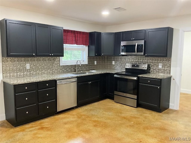 215 Indian Ln, Tallassee, AL 36078 - kitchen featuring appliances with stainless steel finishes, a sink, light stone counters, decorative backsplash, and recessed lighting