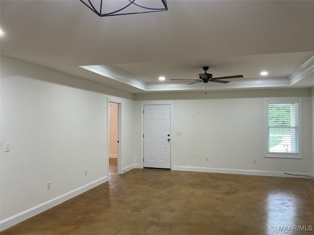 215 Indian Ln, Tallassee, AL 36078 - spare room with a tray ceiling, ornamental molding, baseboards, ceiling fan, and concrete floors