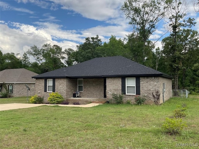 215 Indian Ln, Tallassee, AL 36078 - single story home featuring a front yard, brick siding, and roof with shingles