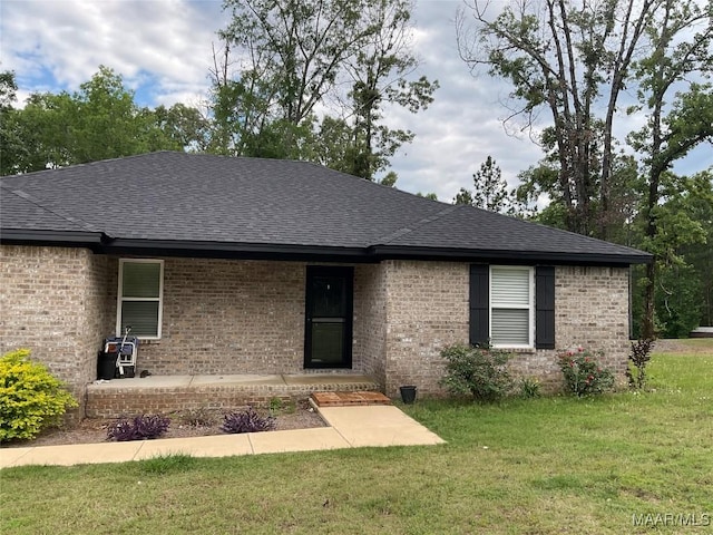 215 Indian Ln, Tallassee, AL 36078 - single story home featuring a shingled roof, brick siding, and a front lawn
